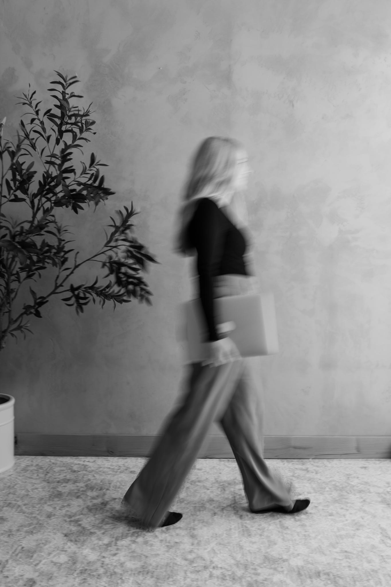 Kenzie Womack walking with laptop always moving, always creating